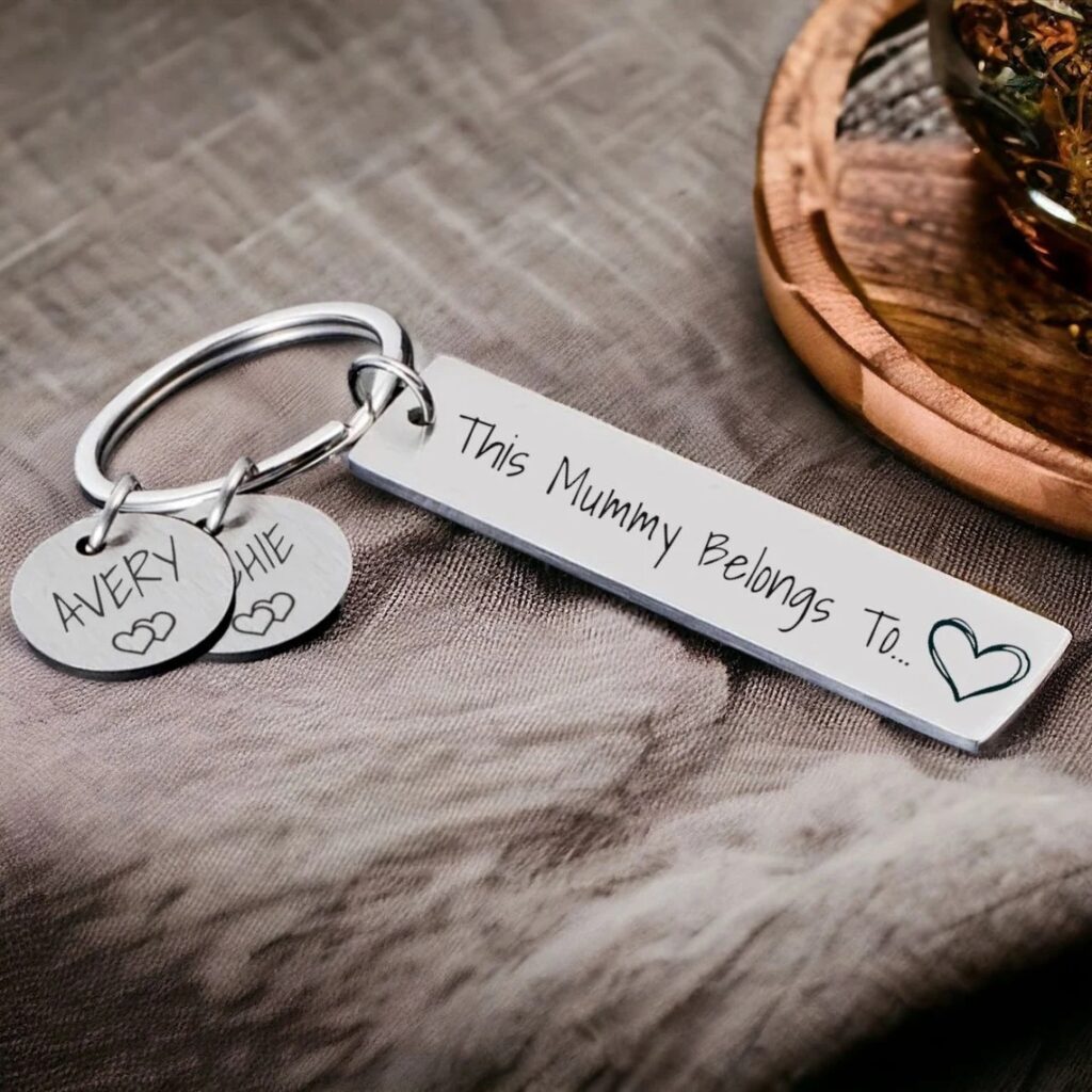 Personalized keychain with the phrase "This Mummy Belongs To" and two heart-shaped pendants with children's names.