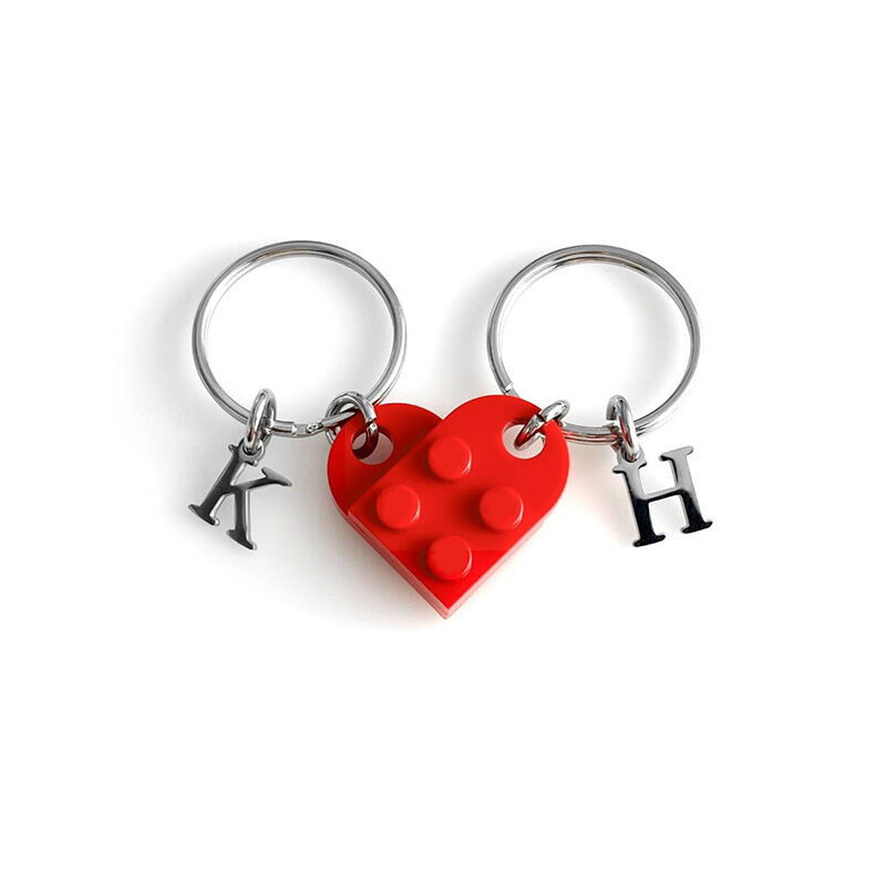 Red heart-shaped keychains with initials "K" and "H", designed for couples, shown on a white background.