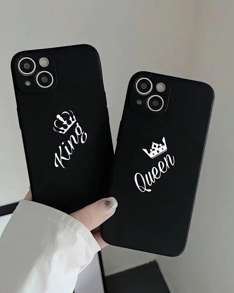 Two black iPhone cases held side by side, one labeled 'King' with a crown symbol and the other 'Queen' with a crown, against a neutral background.