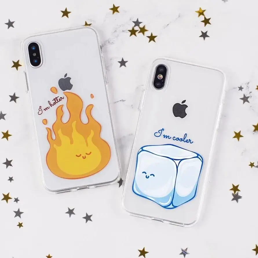 Two iPhone cases on a marble surface with golden stars; one with a happy flame saying 'I'm hotter' and the other with a smiling ice cube stating 'I'm cooler'.