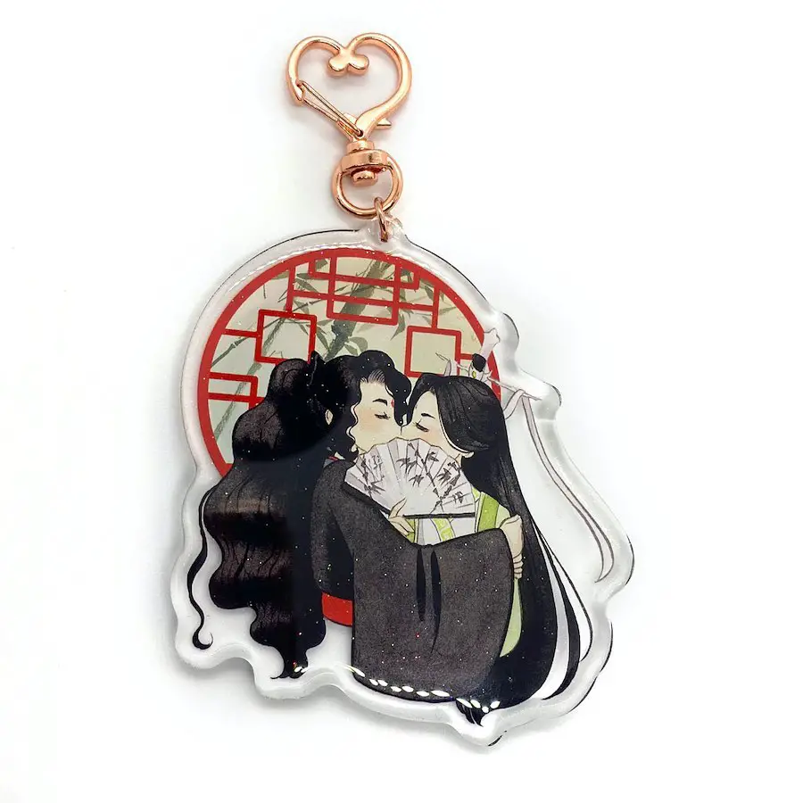 A keychain depicting a tender embrace between two anime characters under a red circular background, enhanced with cultural motifs.