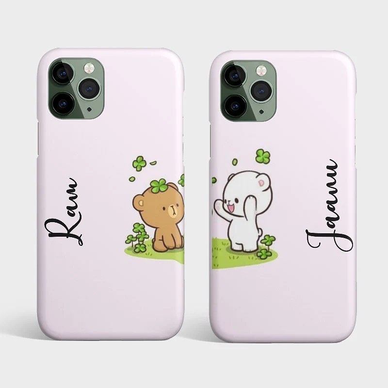 Two pastel-colored iPhone cases, each with a cute bear character and personalized names 'Ravi' and 'Jannu', set in a cheerful clover field.