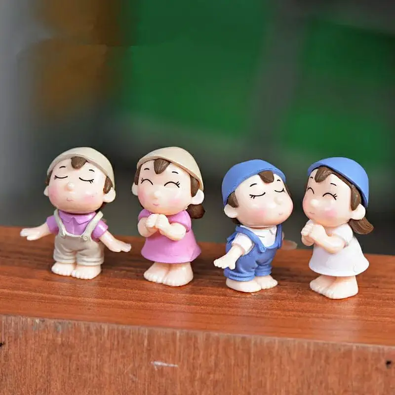 A set of four cartoon-style keychains featuring children in pastel outfits, each displaying a playful gesture.