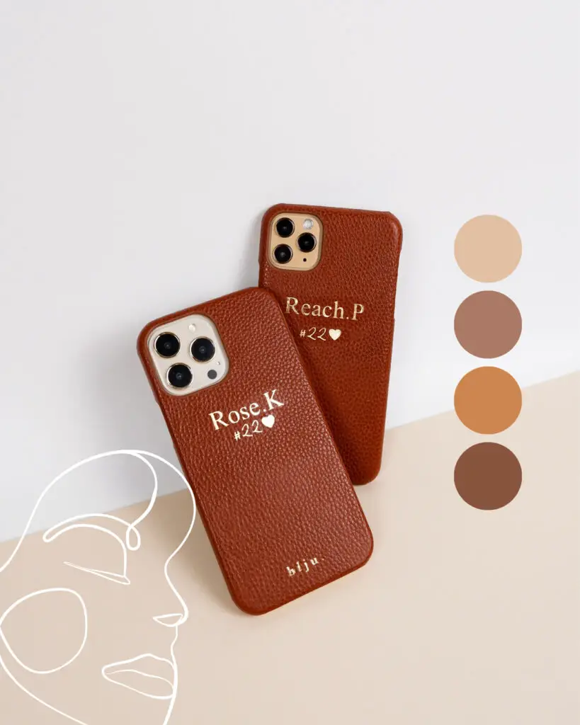 Two personalized brown leather iPhone cases, one with 'Reach.P #22' and the other with 'Rose.K #22', set against a minimalist artistic backdrop.