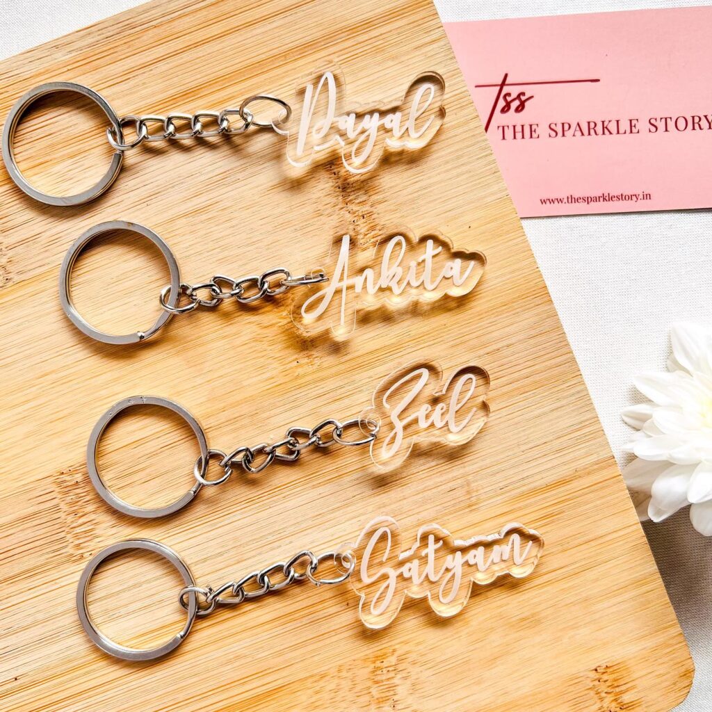 Wooden keychains engraved with personal names in a decorative cursive font.
