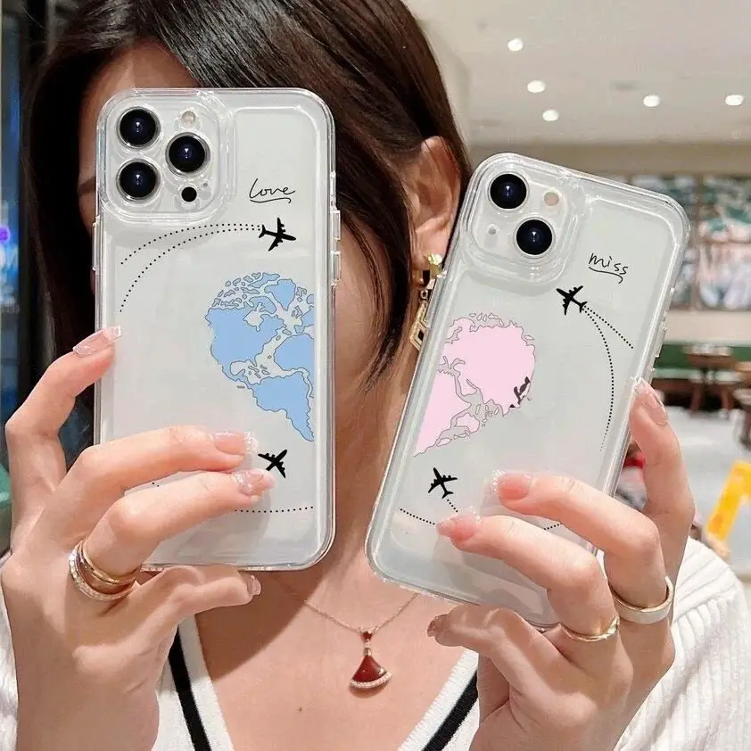 A woman holds two phone cases with world map designs in blue and pink, labeled with words "love" and "miss," symbolizing long-distance relationships.