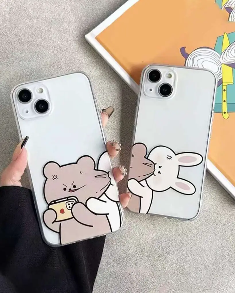 Two smartphones with cartoon designs of a bear using a phone and a bunny blowing a kiss, held against a neutral background.
